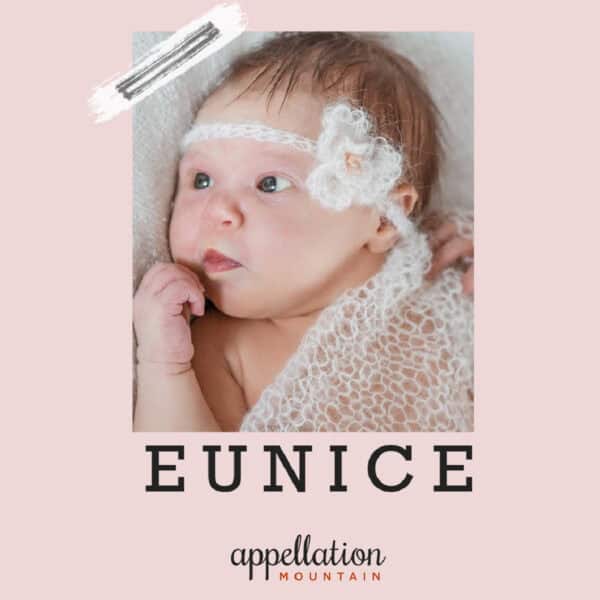 baby girl with short light brown hair wearing floral headband and crocheted blanket; baby name of the day Eunice