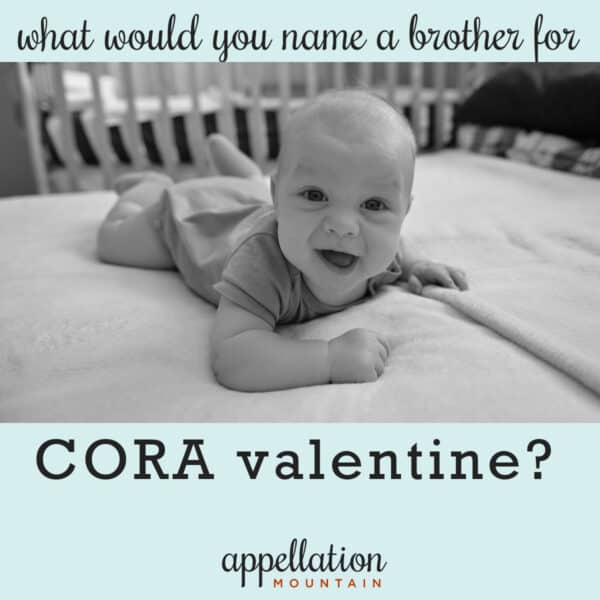 baby boy on belly in crib on white sheet; "name a brother for Cora Valentine"