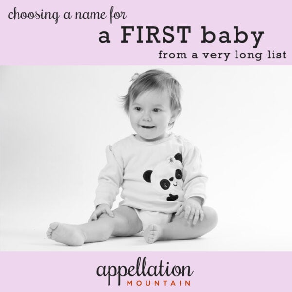 baby girl with light hair wearing a panda print onesie sitting up; "choosing a name for a first baby from a very long list"