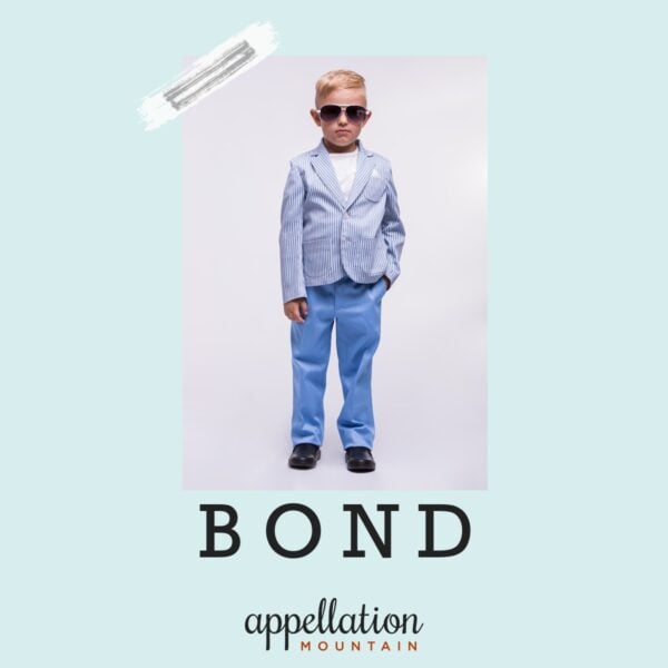 blonde toddler boy child wearing blue jacket and jeans and sunglasses "baby name Bond"