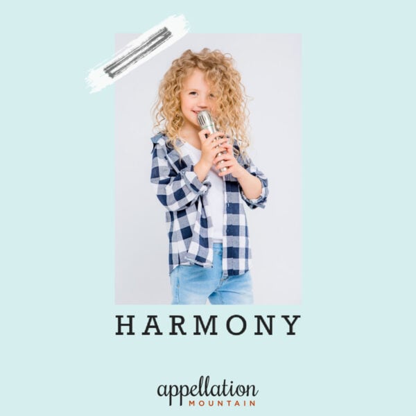 girl with blonde curls wearing blue plaid shirt and jeans holding microphone "baby name Harmony"