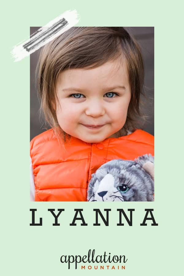 young girl with brown hair in an orange puffer vest holding a stuffed cat; baby name Lyanna