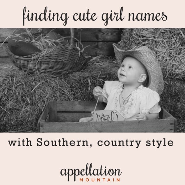 baby girl wearing cowboy hat sitting in barn with hay bales; finding cute Southern girl names