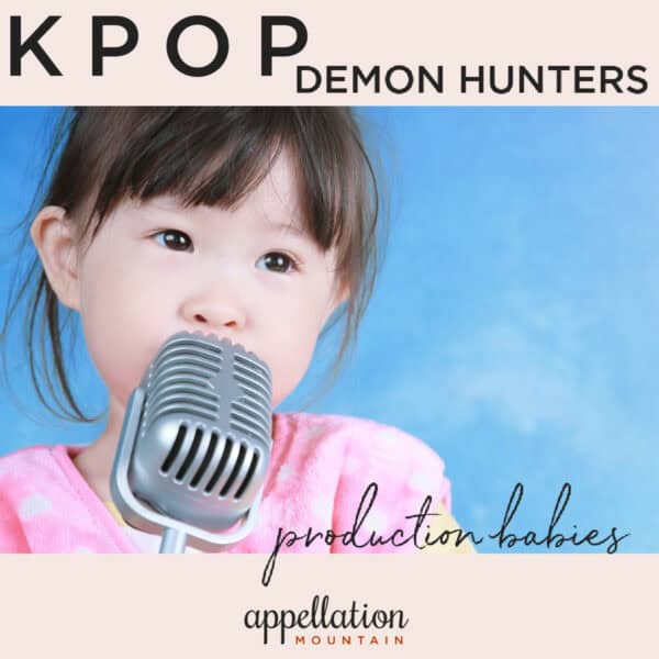 toddler girl of Asian descent wearing pink top and singing into microphone; KPop Demon Hunters production babies