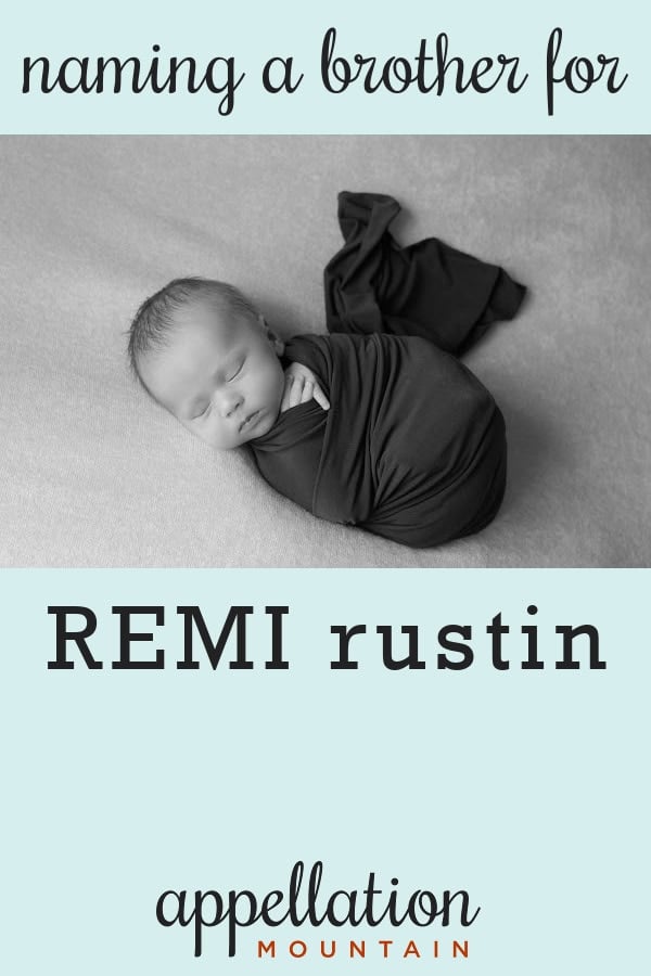 sleeping baby boy wrapped in dark blanket: brother for Remi