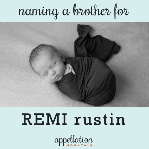 sleeping baby boy wrapped in dark blanket: brother for Remi