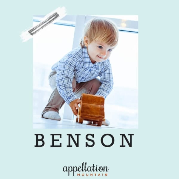blonde toddler boy wearing blue shirt pushing toy truck; baby name Benson