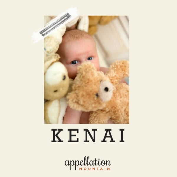 baby boy with light hair laying on off white blanket surrounded by teddy bears; baby name Kenai