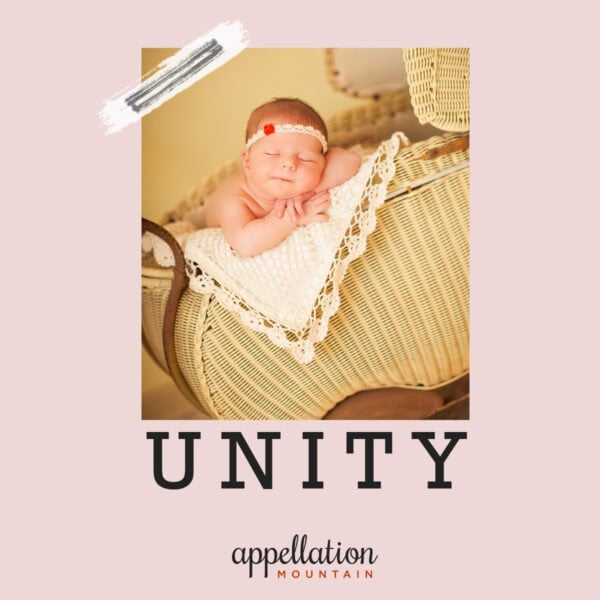 baby girl wearing headband sleeping in old-fashioned wicker pram with ivory blanket; baby name Unity