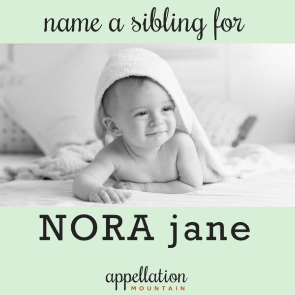 baby raised up on forearms with towel draped over head; finding names like Nora