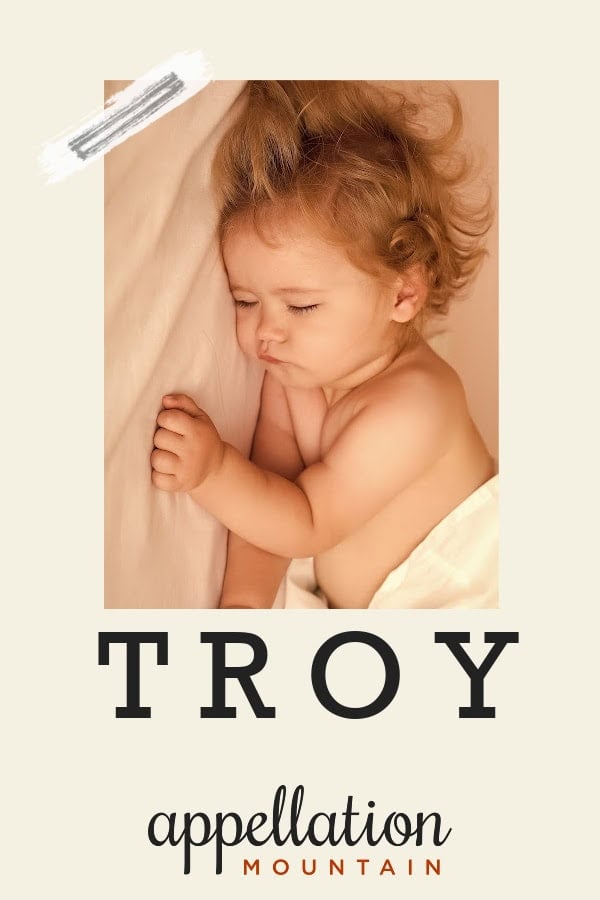 sleeping baby boy with dark blonde curls under a light yellow blanket; baby name Troy