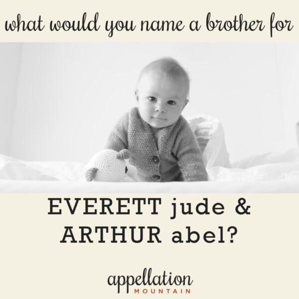 baby boy propped up on arms with stuffed animal on white bedding; naming Everett and Arthur's brother