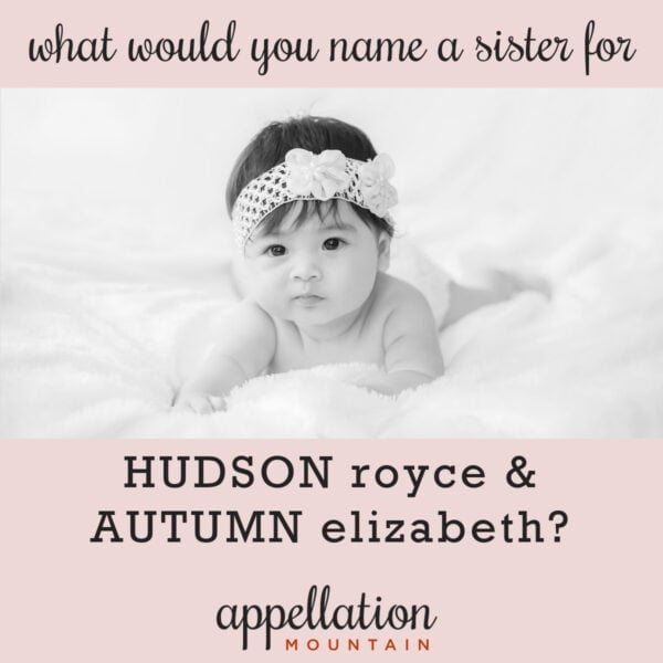 baby girl with dark hair wearing headband stretched out on white blanket; naming a sister for Autumn and Hudson