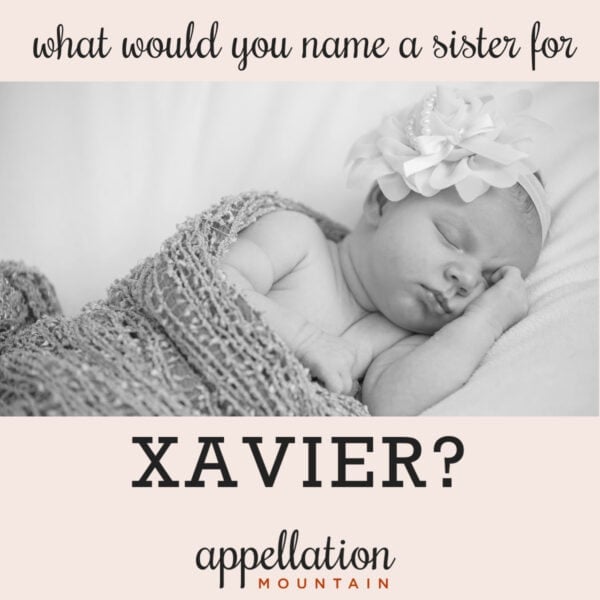 sleeping baby girl with floral headband wrapped in blanket; naming Xavier's sister