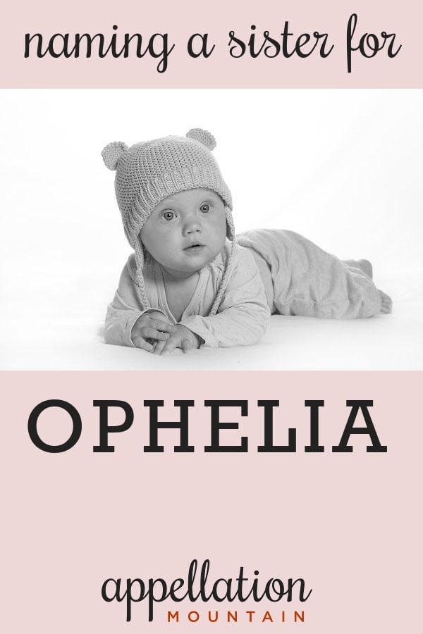 baby wearing knit hat with pom poms resting on stomach; names like Ophelia