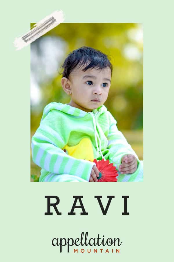 baby boy of Indian descent wearing light green fuzzy jacket sitting outside in a park; baby name Ravi