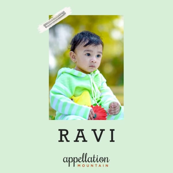 baby boy of Indian descent wearing light green fuzzy jacket sitting outside in a park; baby name Ravi