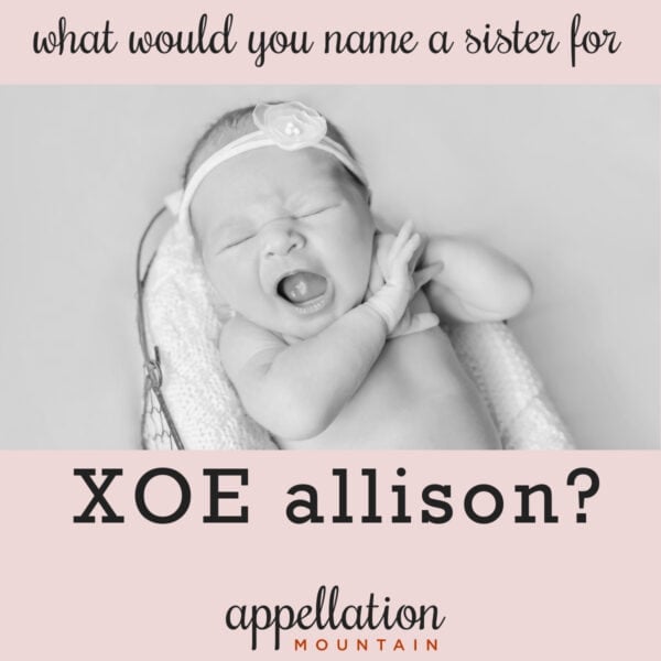 baby girl yawning, wearing headband, in Moses basket; name a sister for Xoe Allison