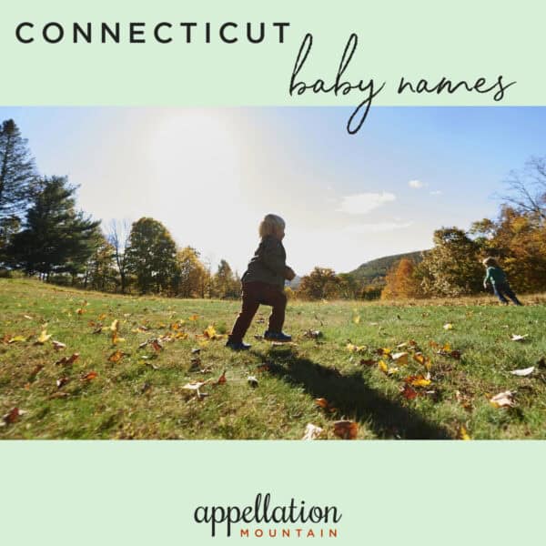 child running in field with fallen leaves; Connecticut baby names