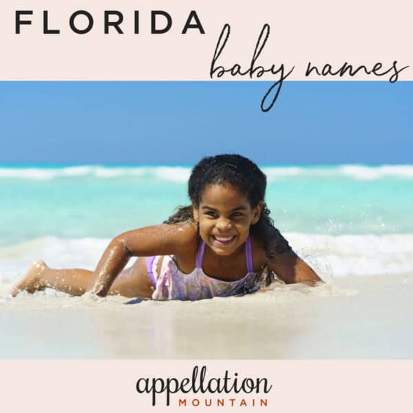 African American girl child lying on the beach in the sand; Florida baby names