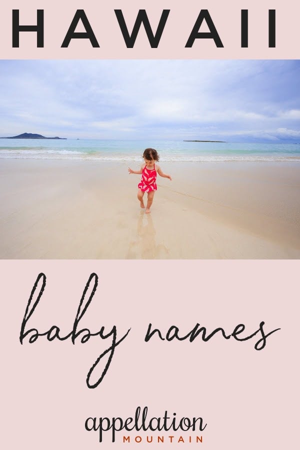 toddler girl with dark hair wearing bright pink swimsuit on beach; Hawaii baby names