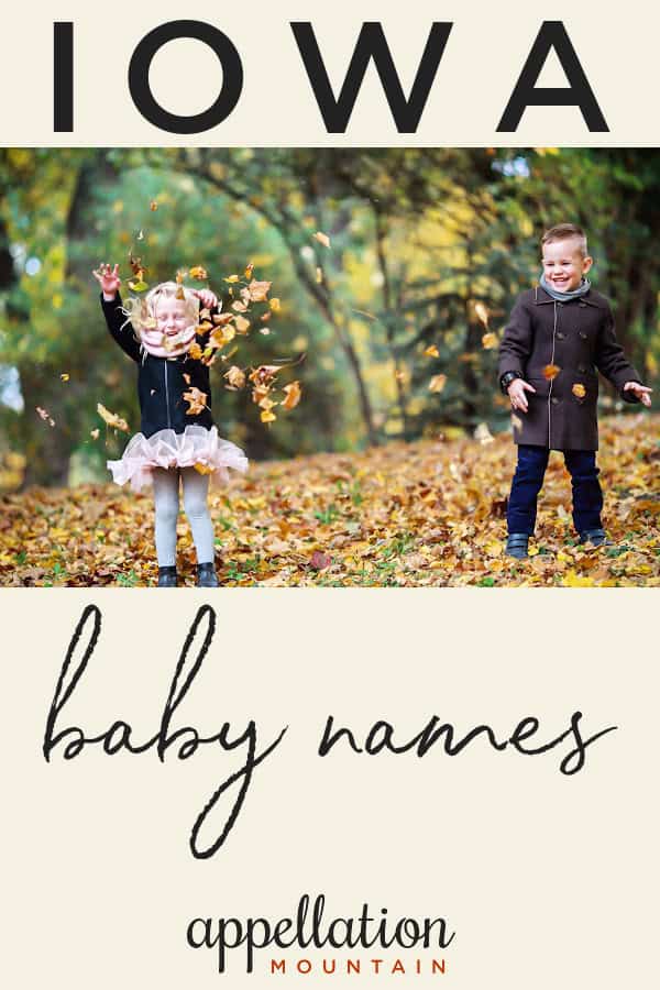 two children tossing oak leaves in the air standing in autumn woods; Iowa baby names
