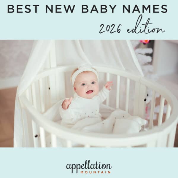 baby in round white wooden crib with white curtain; new baby names 2026
