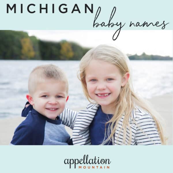 blonde boy and girl wearing navy rash guards sitting in front of lake; Michigan baby names