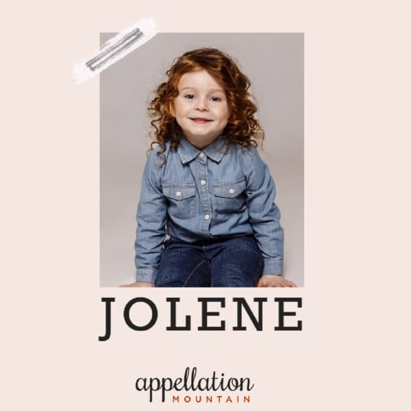 girl child with brown curly wearing wearing blue button up shirt and jeans; baby name Jolene