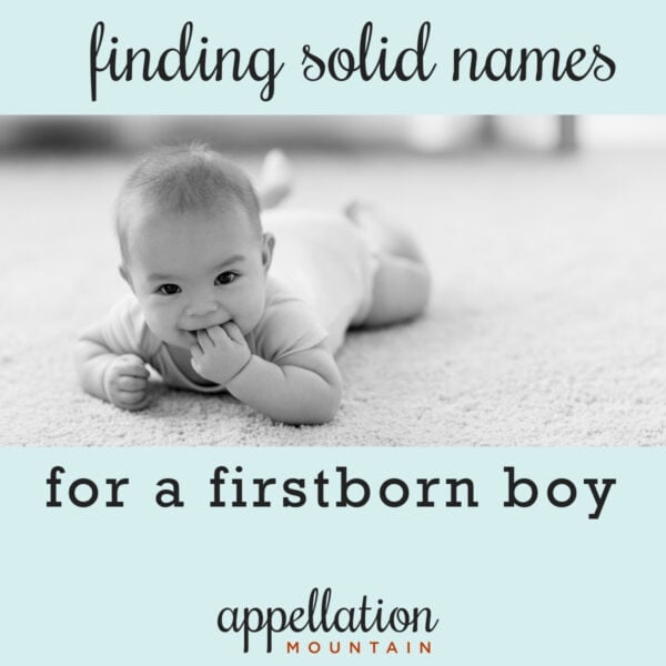 baby boy lying on stomach on carpet with hands in mouth; solid boy names for a firstborn