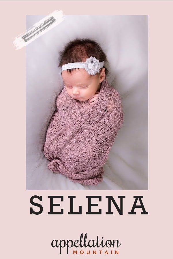 sleeping baby girl with dark hair wearing headband wrapped in pink blanket; baby name Selena