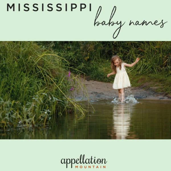 girl child with long hair wearing a pale sundress wading into river; Mississippi baby names