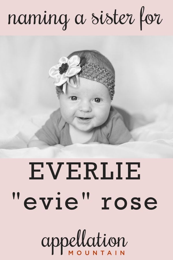 girl baby wearing knit headband with flower, smiling; mismatched names for Everlie's sister