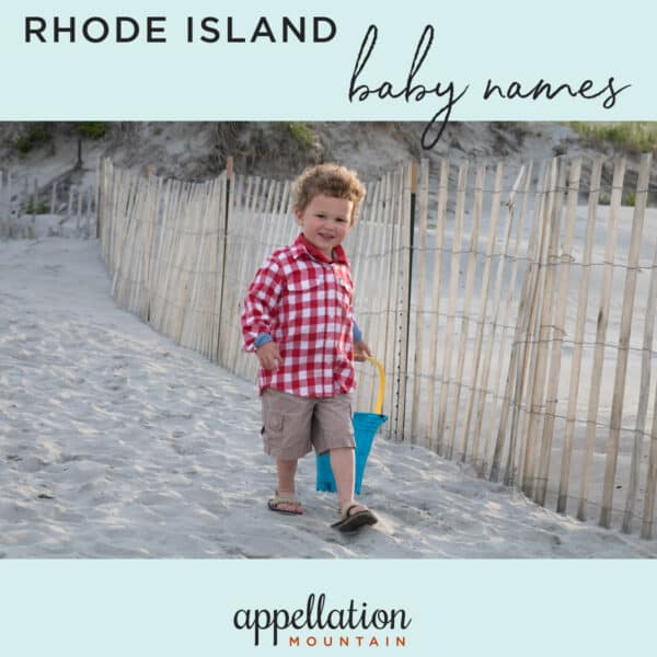 boy child wearing red checked shirt and shorts walking along fence at beach; Rhode Island baby names