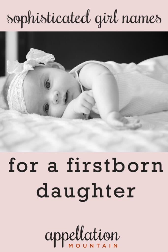baby girl wearing lace headband lying on her side; sophisticated names for girls